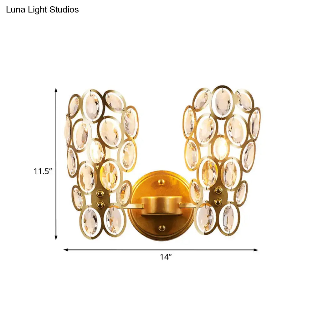 Modern gold crystal wall lamp featuring multiple oval clear crystals arranged in symmetrical wing-like clusters for bedroom use