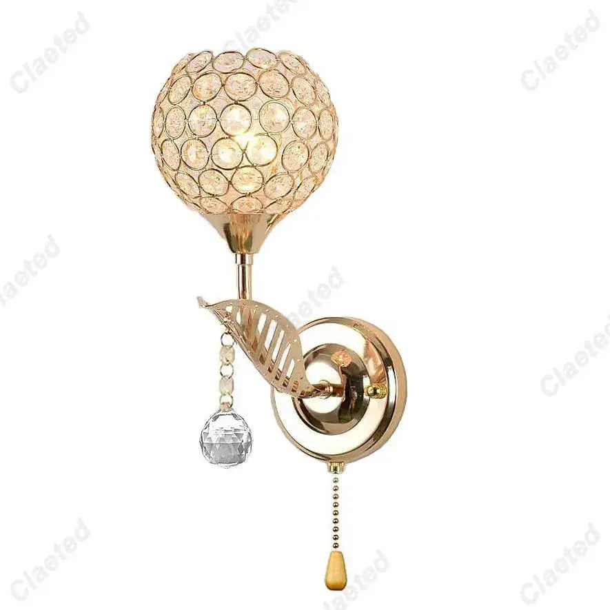 Modern gold crystal wall lamp featuring a spherical globe and decorative leaf accent for elegant bedroom decorbites decor