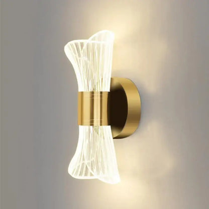 Modern gold crystal wall lamp with sculptural translucent ribbed glass shade emitting warm ambient light decorbites crystal wall lamp
