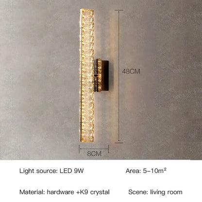 Modern gold crystal wall lamp with stacked k9 panels and dark hardware emitting warm light for living room decorbites crystal wall