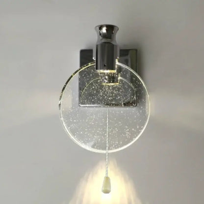 Modern gold crystal wall lamp with chrome finish and clear glass globe featuring decorbites crystal wall elements and pull cord switch
