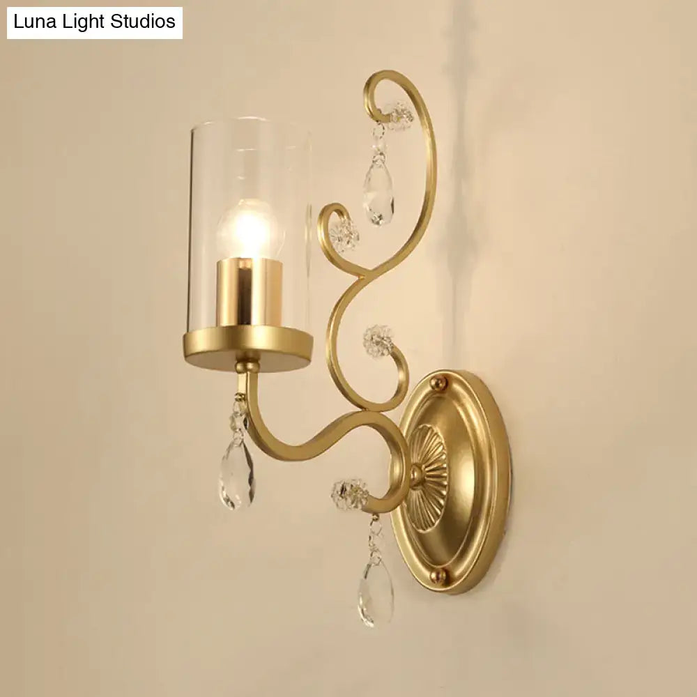 Modern gold wall light with clear glass cylinder shade and crystal droplets for bedroom lighting