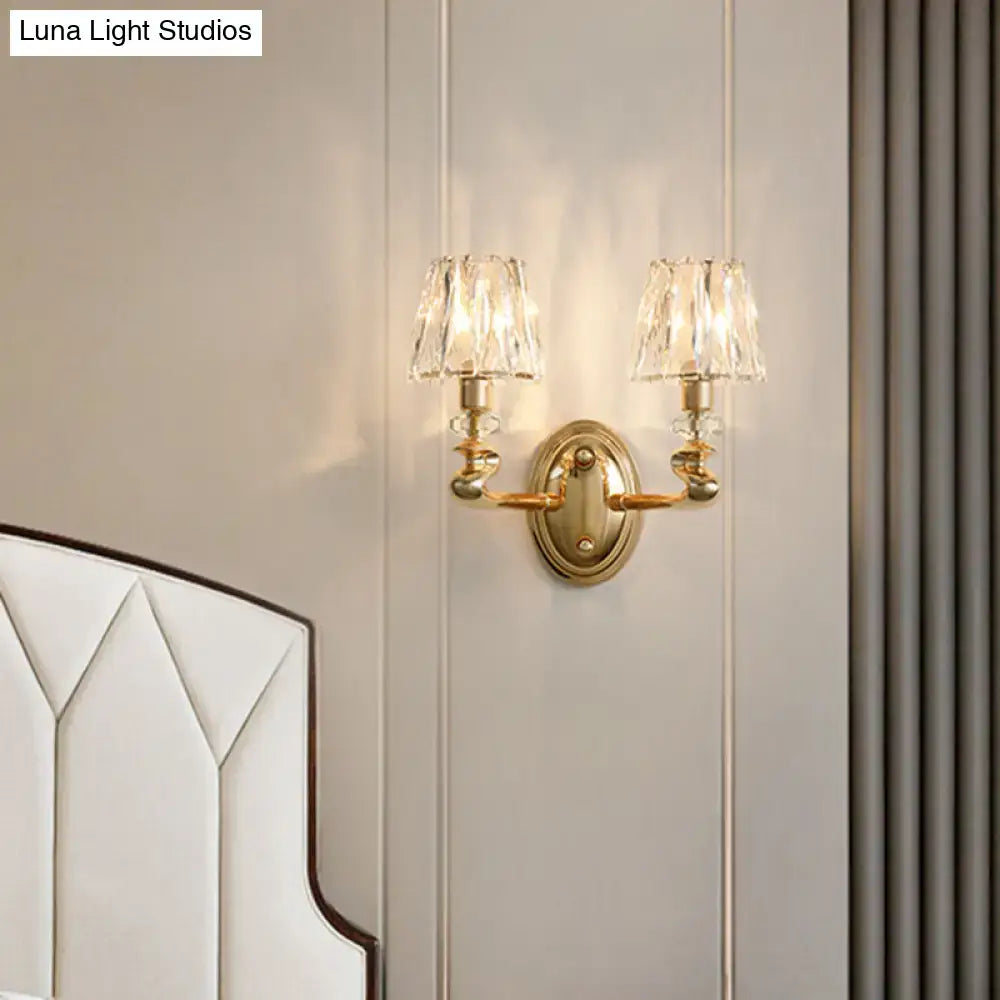 Modern gold wall light fixture with crystal lampshades designed as a stylish bedroom light fixture