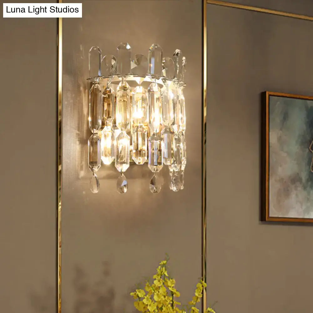 Modern gold crystal wall mount lighting with clear faceted glass prisms and gold-toned metal frame for living room sconce