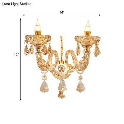 Modern gold crystal wall sconce inch fixture with two arms and dangling teardrop crystals for bedroom use
