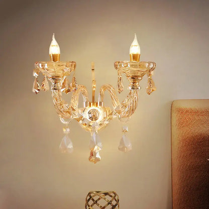 Modern gold crystal wall sconce with two candle-style bulbs and faceted glass ornaments inch fixture for bedroom