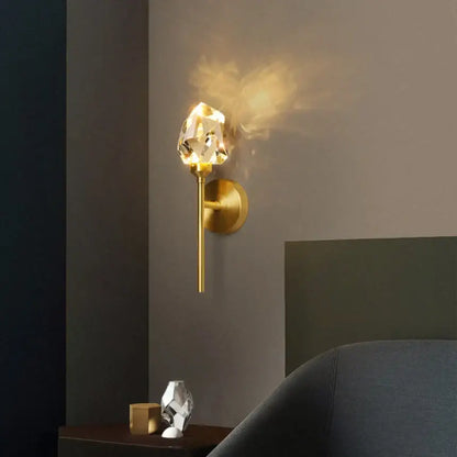 Modern gold crystal wall sconce with a faceted crystal shade and led illumination by decorbites crystal wall fixture