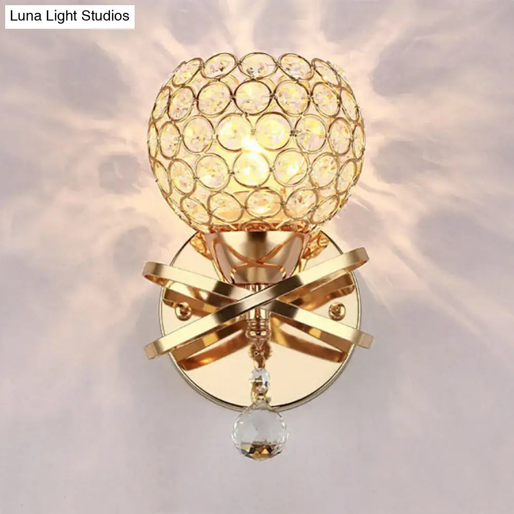 Modern gold crystal wall sconce with spherical globe, intersecting metal bands, and dropped crystal ball wall light for bedroom