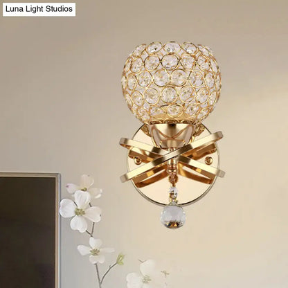 Modern gold crystal wall sconce with intersecting metal arms and dropped crystal ball for elegant wall light