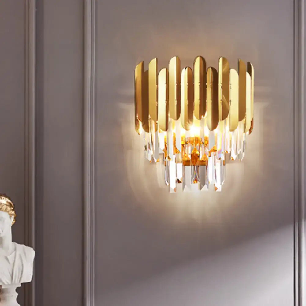 Modern gold wall sconce with vertical metallic plates and dangling crystal prisms for corridor wall lamp use