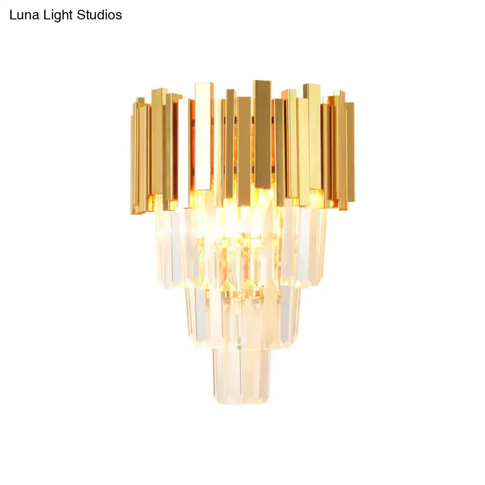 Modern gold crystal wall sconce with vertical bars featuring a gold-toned frame and clear crystal for living room use