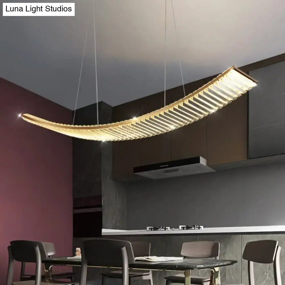 Modern gold curved crystal chandelier with horizontal slats emitting warm light suspended crystal chandelier