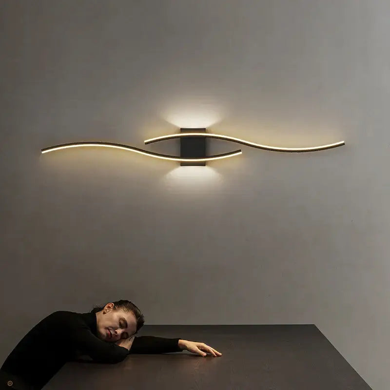 Modern gold curved led wall lamp with sleek design and warm ambient lighting for bedroom use