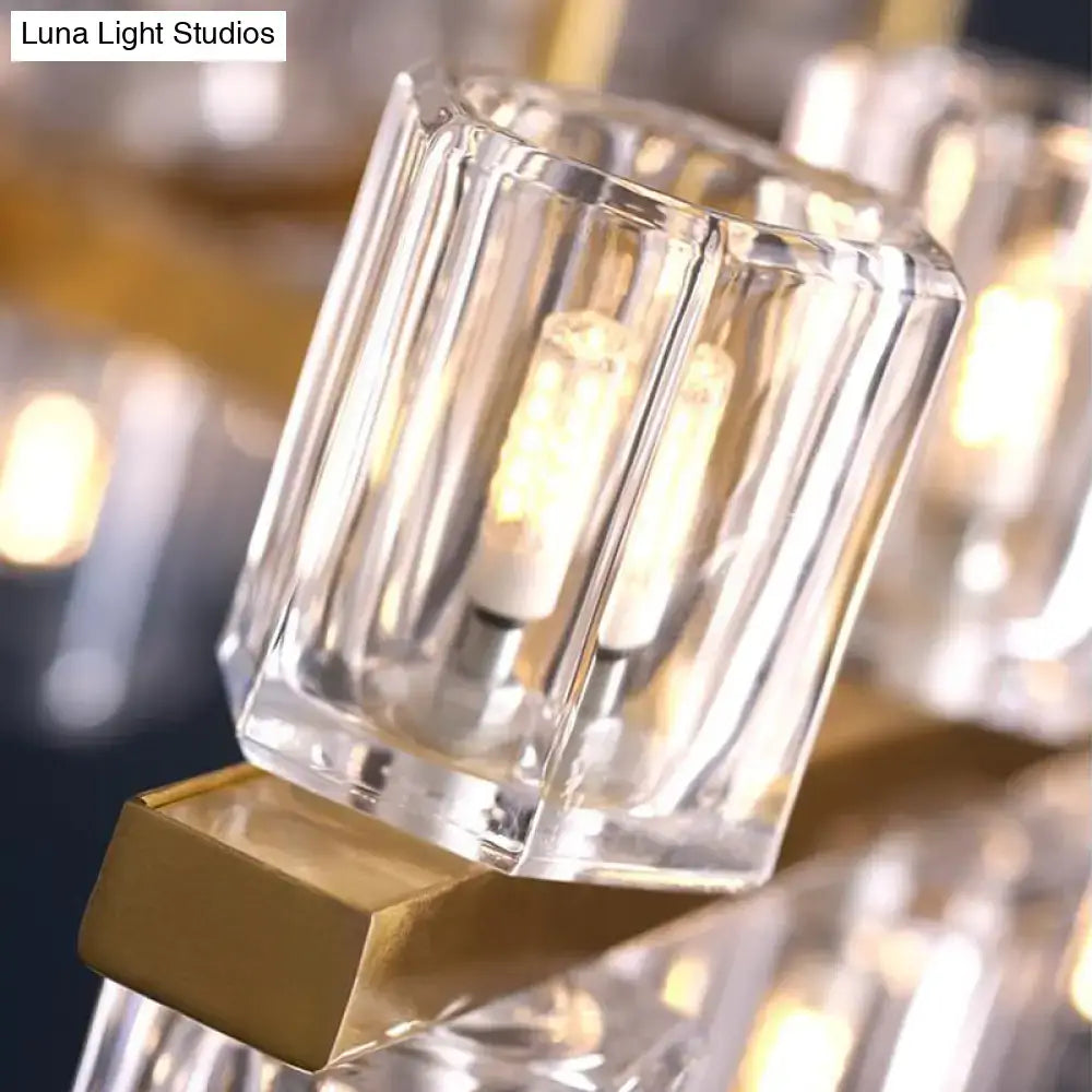 Clear faceted glass chandelier shade with gold-toned metal base in modern gold cylinder island light fixture