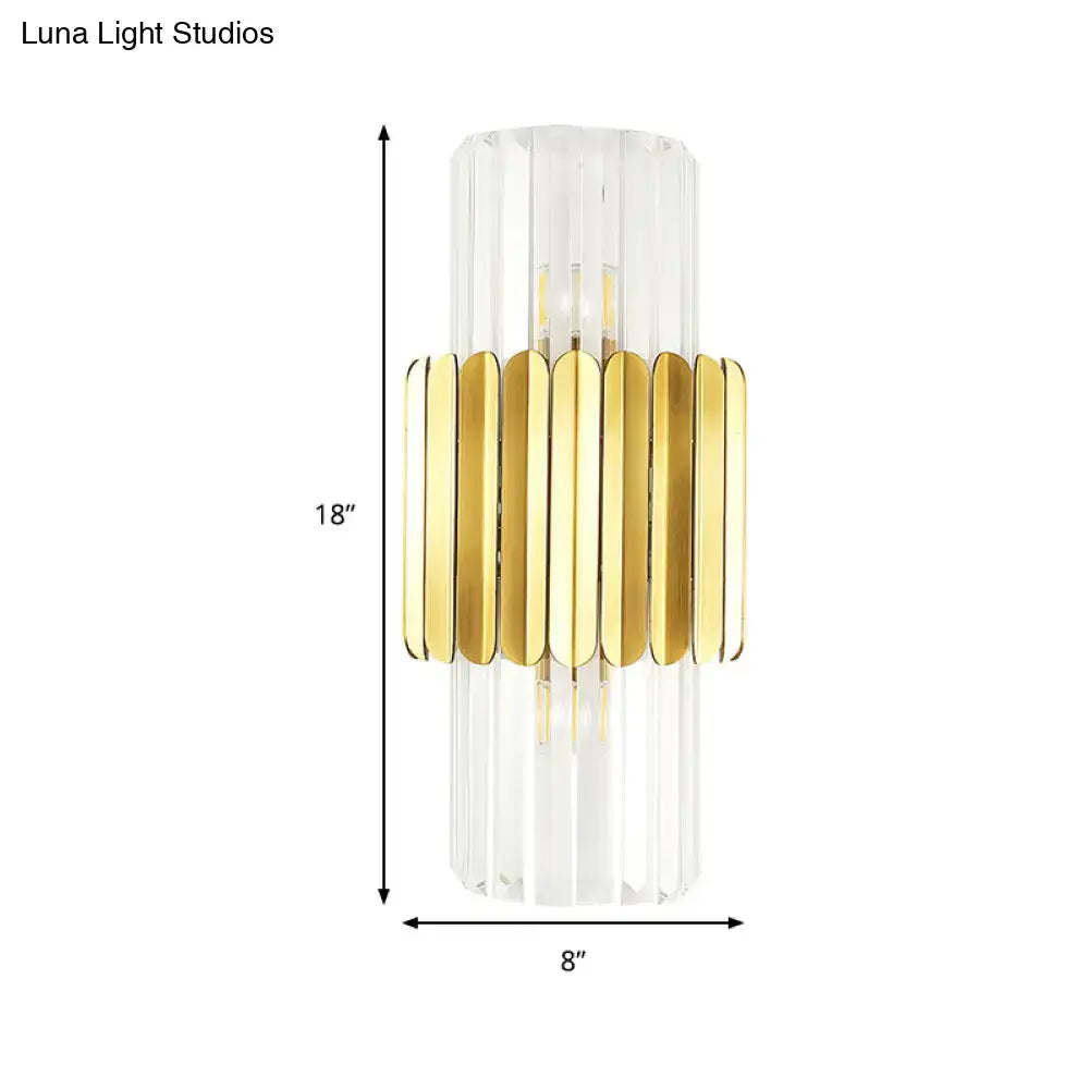 Modern gold cylinder wall mount lamp with clear faceted crystal body and horizontal metal bands for bedroom use