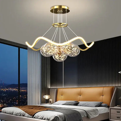 Modern gold decorbites bubble chandeliers with curved metallic arms and three glass globe shades for dining room lighting