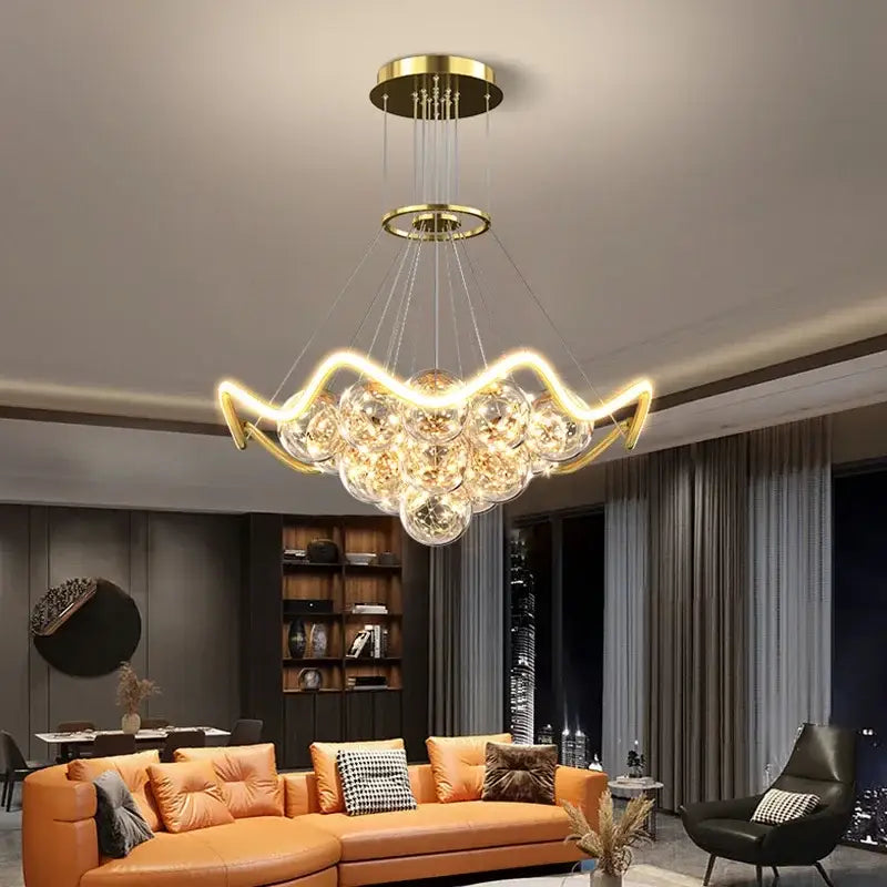 Modern gold decorbites bubble chandeliers with clear glass spheres and curved metallic arms for dining room led light