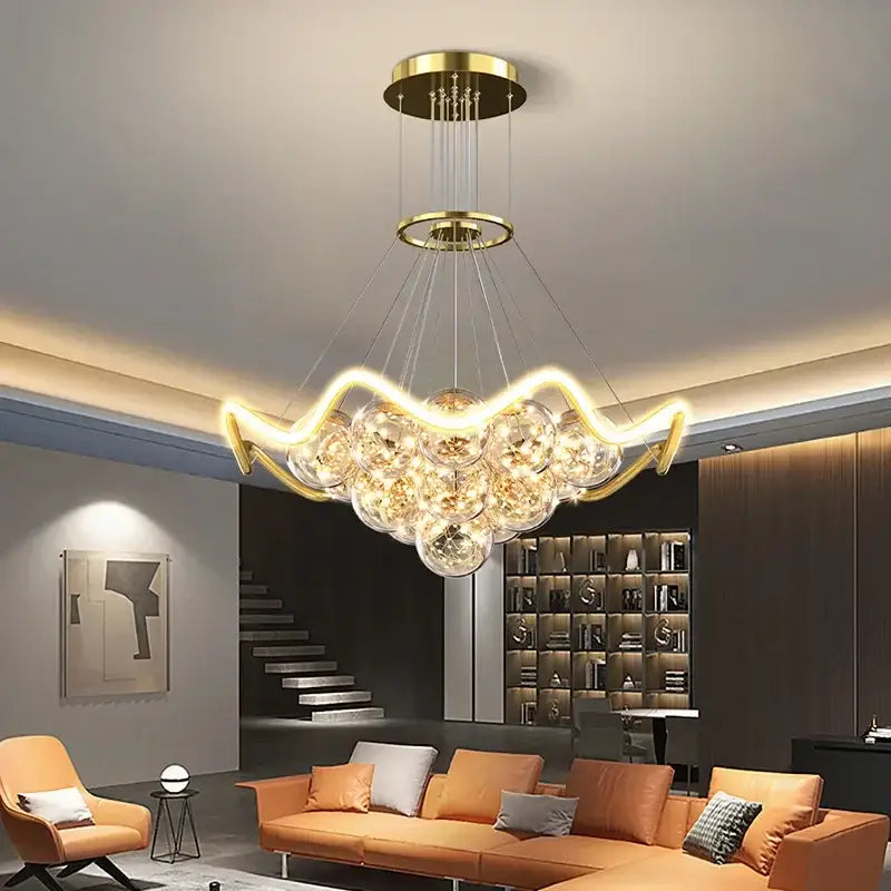 Modern gold decorbites bubble chandeliers with curved led light arms and clear glass spheres for dining room lighting