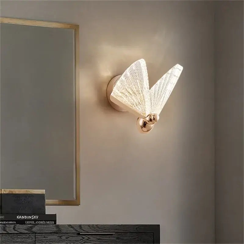Modern gold decorbites butterfly wall light with translucent textured glass wings and polished brass base for bedroom decor