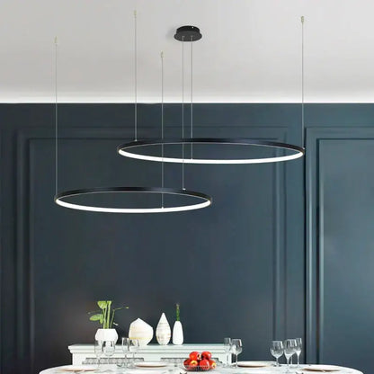 Modern gold decorbites circular led chandelier with sleek black circular pendant lights for dining room illumination