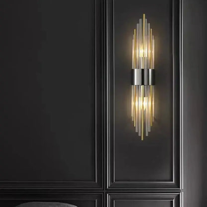 Modern wall lamp featuring decorbites clear crystal led with vertical glass rods in gold and black metal accents for bedroom