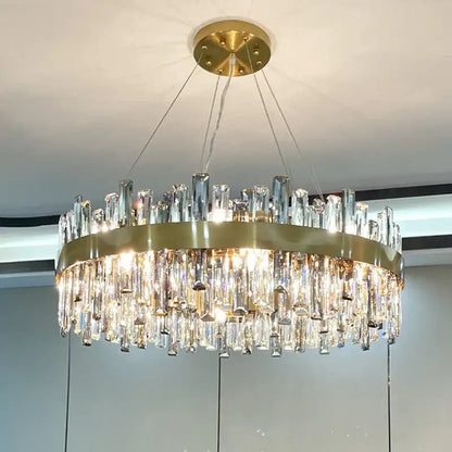 Modern gold decorbites crystal chandelier with circular metal frame and cascading clear crystal prisms for living room