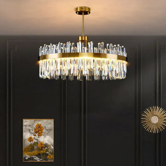 Modern gold decorbites crystal chandelier with clear faceted prisms in cascading tiers for living room and dining room
