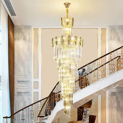 A modern gold decorbites crystal chandelier with multi-tiered crystals hangs above a staircase for elegant living room decor