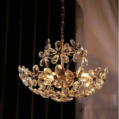 A modern gold decorbites crystal flower two-tiered chandelier with faceted crystals for living room decor