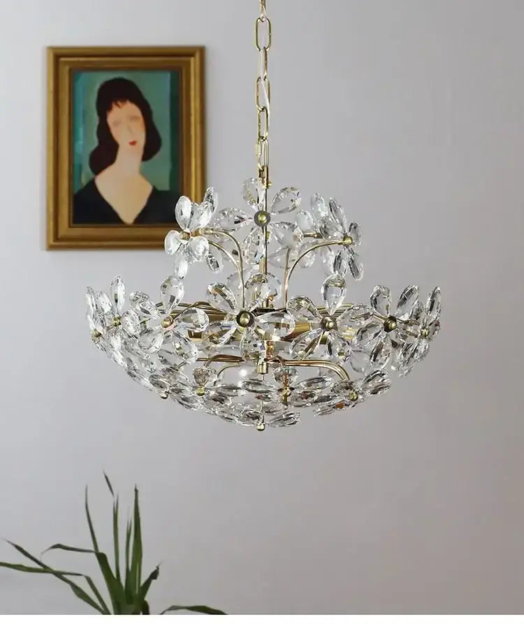 A modern gold decorbites crystal flower chandelier with brass accents and delicate multi-tiered glass pieces for living room