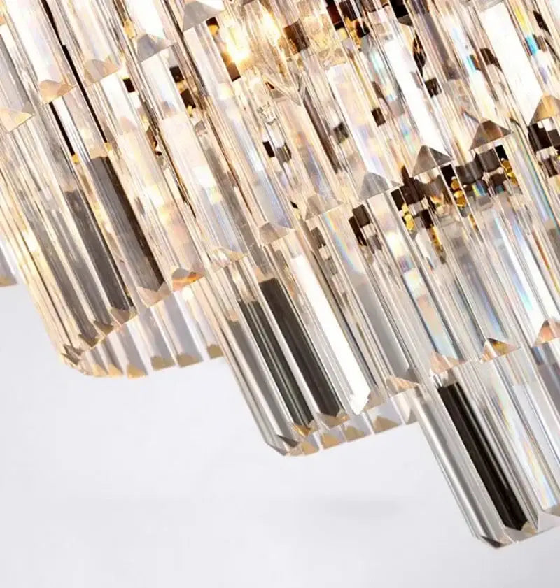 Modern gold decorbites crystal flush ceiling light featuring clear faceted prisms refracting golden iridescent hues