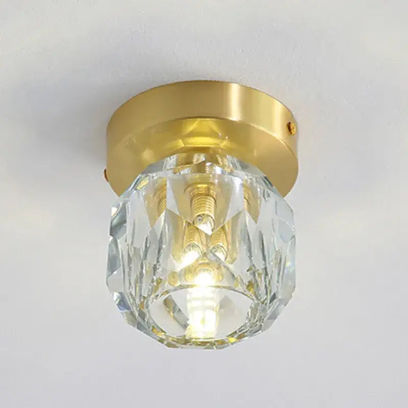 A clear faceted crystal globe with a gold metal base for modern gold decorbites crystal led ceiling light