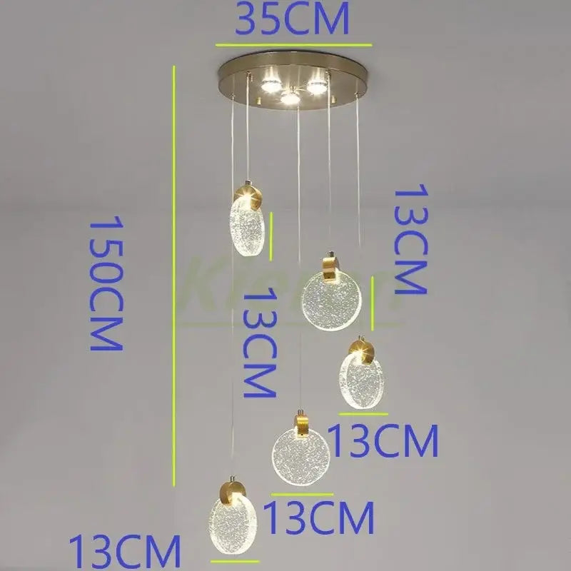 Modern gold decorbites crystal led chandelier with five frosted glass orbs and brushed metal ceiling mount for bedroom use