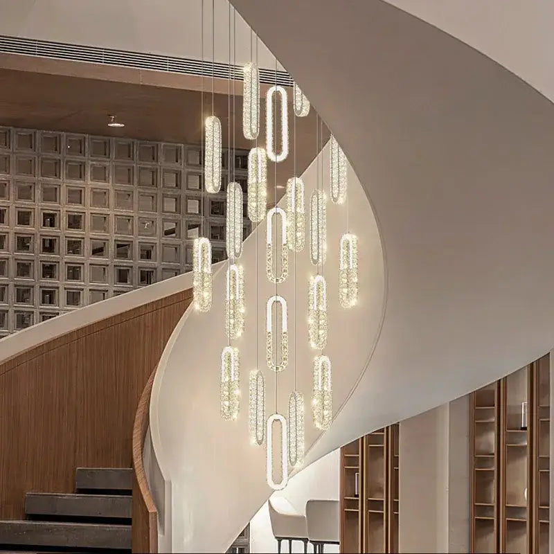 Modern gold decorbites crystal led chandelier with elongated oval pendants emitting warm glow for living room staircase