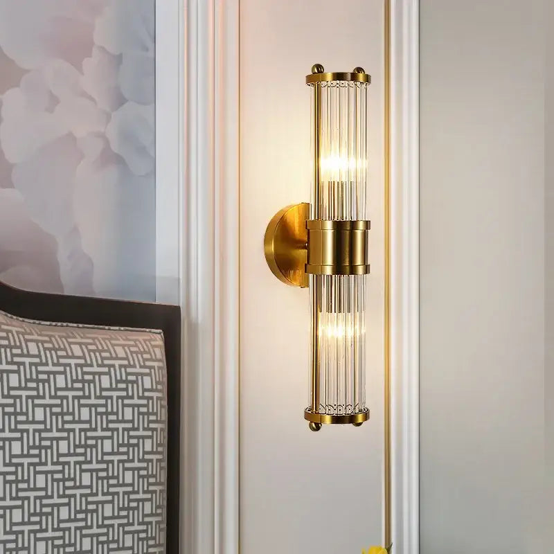 Modern gold decorbites crystal led wall lights featuring a gold-toned wall sconce with vertical glass rods and sleek design