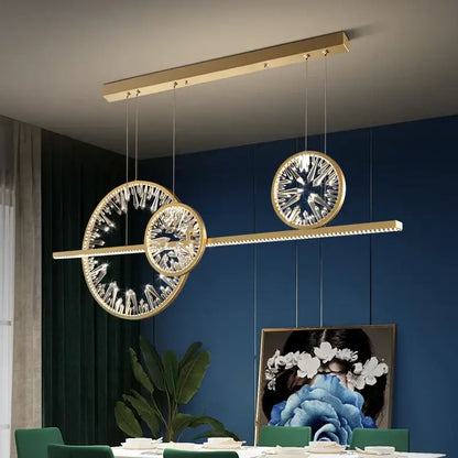 Modern gold decorbites crystal pendant chandelier featuring crystal-encrusted circular elements for dining room lighting