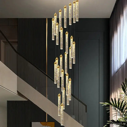 Golden-tipped decorbites crystal staircase chandelier with cascading cylindrical glass tubes filled with sparkling particles