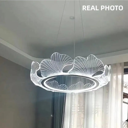 A modern gold decorbites ginkgo acrylic led pendant with glowing white light and intricate ginkgo leaf design for dining room