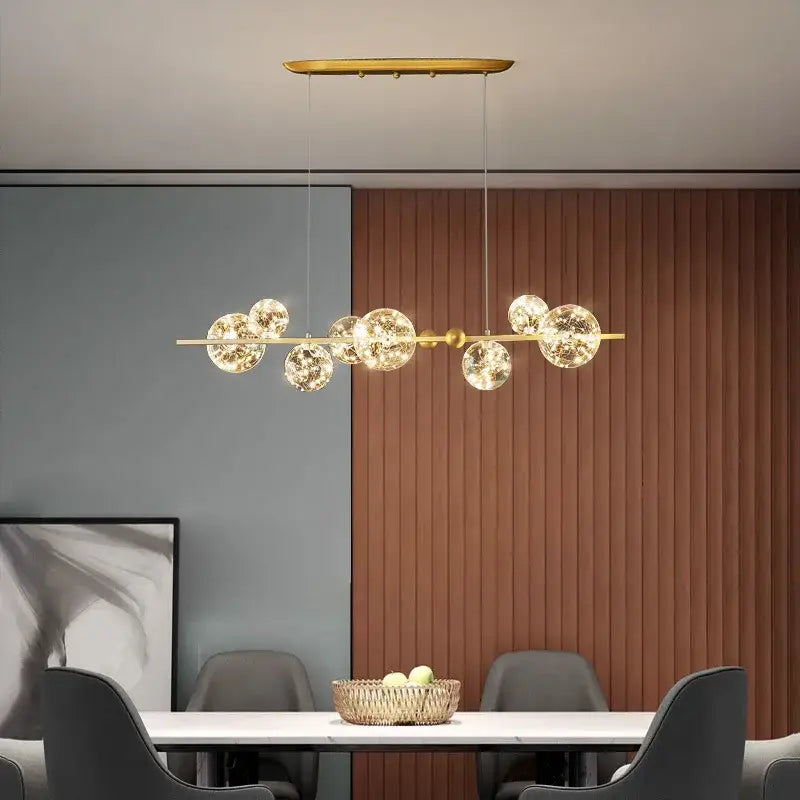Modern gold decorbites glass ball chandelier features spherical glass globes suspended from a sleek horizontal bar for dining room