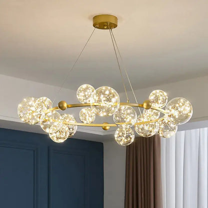 Modern gold decorbites glass ball chandelier with clear glass spheres and warm led lights for dining room lighting