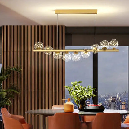 Modern gold decorbites glass balls chandelier with clear glass globe bulbs suspended from sleek horizontal bar