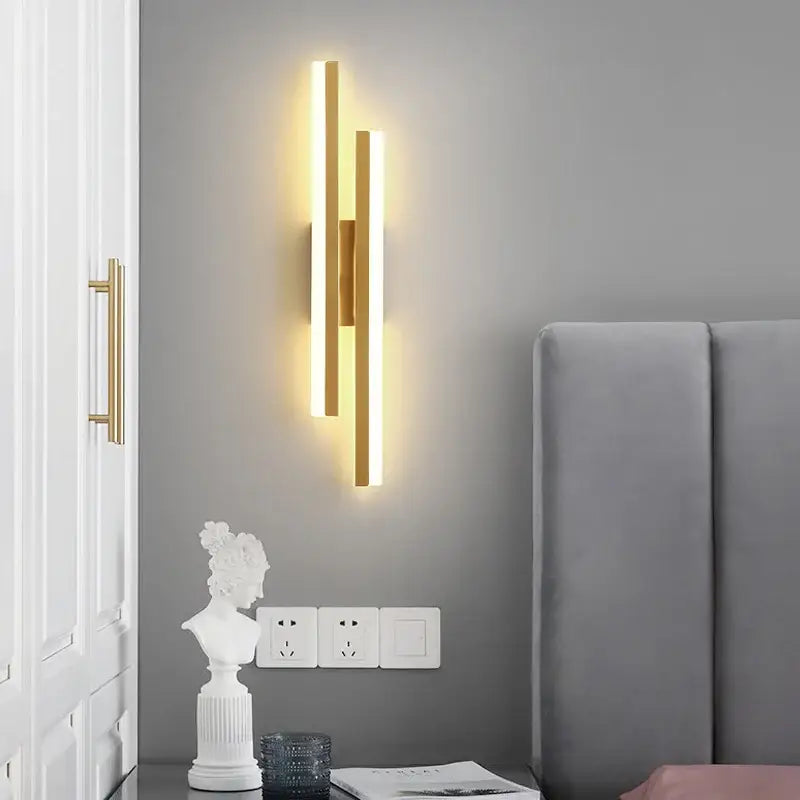 Modern gold decorbites led strip wall lamp with three vertical bars emitting warm soft glow for bedroom sconce lighting
