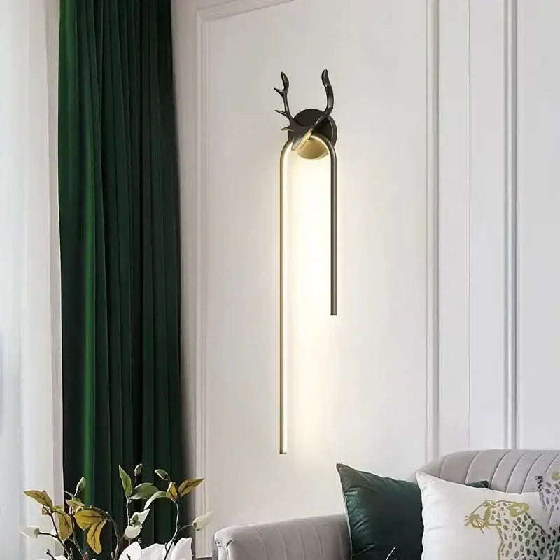 Modern black and gold decorbites deer head wall lamp with sleek arched LED sconce design for bedroom decor