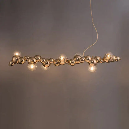 Modern gold designer molecule chandelier pendant light with interconnected spherical bulbs and exposed filament lamps by decorbites