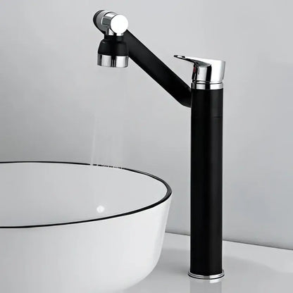 Modern gold detachable spray bathroom sink faucet with black and chrome curved spout beside white ceramic sink