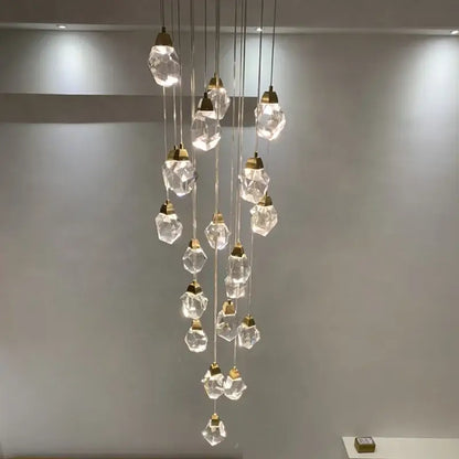 A modern gold diamond crystal ball chandelier with faceted clear glass pendants and metal fixtures for living rooms