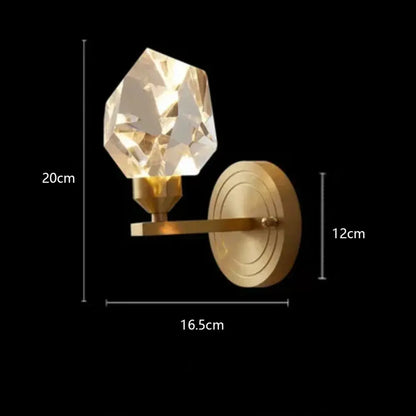A faceted crystal sconce with a gold-toned diamond crystal brass led pendant light arm for modern dining rooms