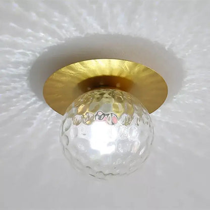 Modern gold diamond crystal ceiling lights featuring a clear textured glass globe and hammered gold metal base