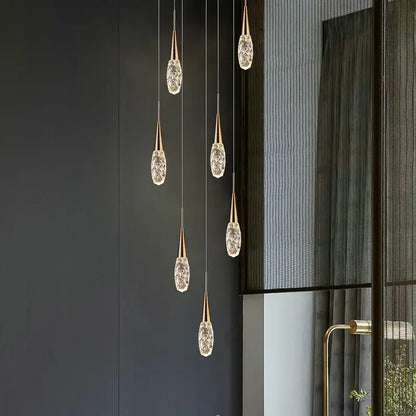Five gold-toned modern diamond crystal chandelier pendant lights with faceted crystal glass shades for living room use