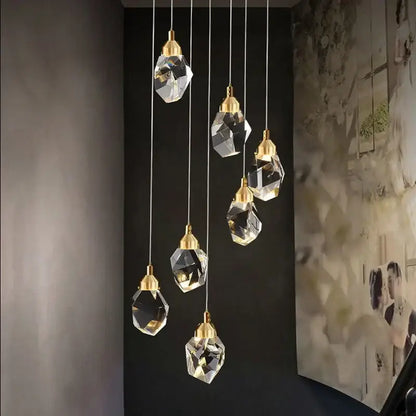 A modern gold diamond crystal chandelier with six faceted glass pendant lights for living room and staircase lighting
